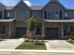 Front view of two attached condos yellow brick