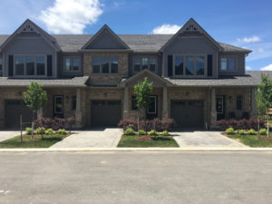 Front view of two attached condos yellow brick