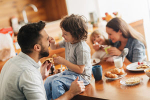 Picture of a young happy family having breakfast together
