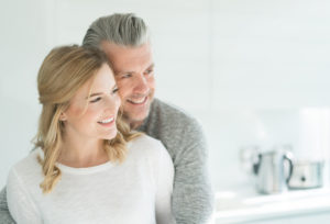 Portrait of a loving couple at home looking very happy and hugging