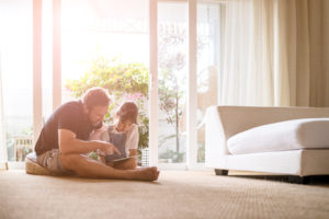 Father and daughter looking at digital tablet.